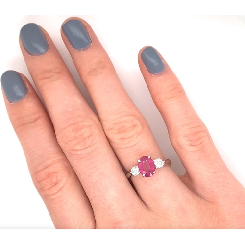 387 - 18k white gold Ruby and Diamond 3 stone ring, 1.85ct oval cut ruby centre, and 0.38ct diamonds to th... 