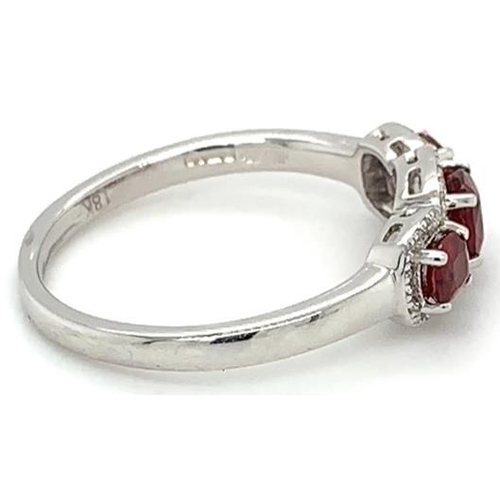 473 - 18k white gold Ruby and Diamond ring, 0.72ct of 3 stones set ruby and 0.11ct diamonds halo setting, ... 