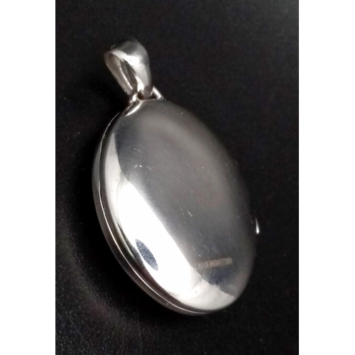 166 - 9K WHITE GOLD DIAMOND SET OVAL LOCKET. TOTAL WEIGHT 3.2G BRAND NEW