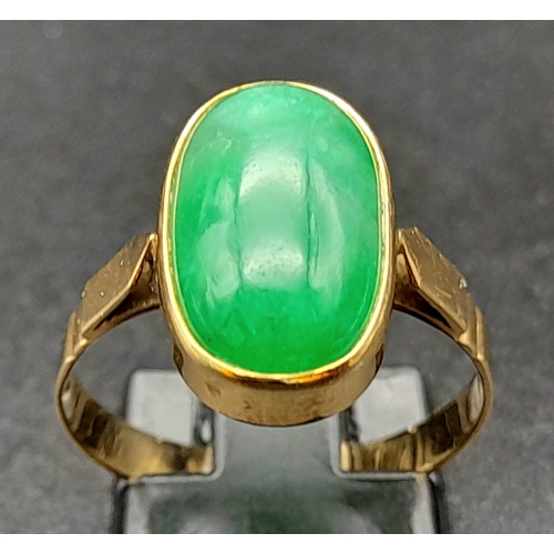 120 - An 18K Yellow Gold Jade Ring. Green jade oval cabochon. Size O. 2.7g total weight.