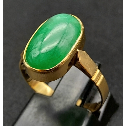 120 - An 18K Yellow Gold Jade Ring. Green jade oval cabochon. Size O. 2.7g total weight.