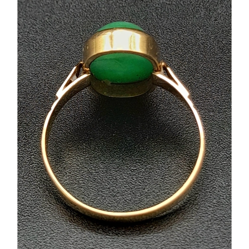 120 - An 18K Yellow Gold Jade Ring. Green jade oval cabochon. Size O. 2.7g total weight.