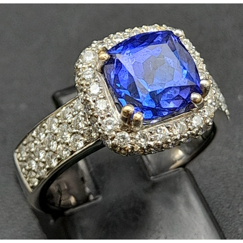 773 - An 18K White Gold 3.4ct Tanzanite Ring. Cushion mixed-cut natural tanzanite with 94 brilliant round ... 