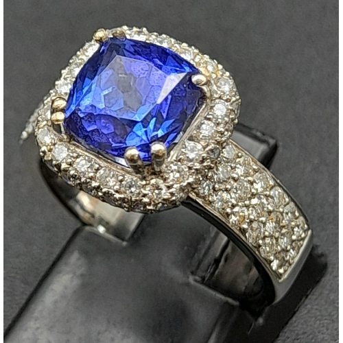 773 - An 18K White Gold 3.4ct Tanzanite Ring. Cushion mixed-cut natural tanzanite with 94 brilliant round ... 