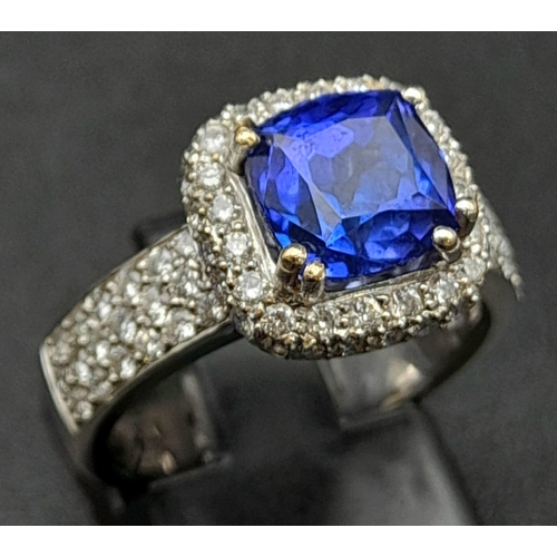 773 - An 18K White Gold 3.4ct Tanzanite Ring. Cushion mixed-cut natural tanzanite with 94 brilliant round ... 