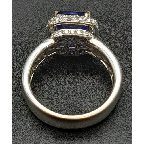 773 - An 18K White Gold 3.4ct Tanzanite Ring. Cushion mixed-cut natural tanzanite with 94 brilliant round ... 