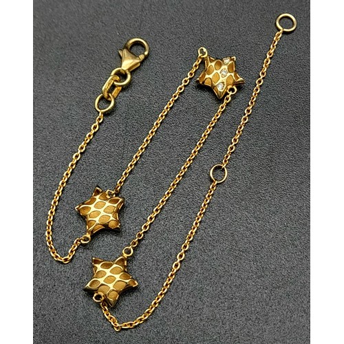 816 - 9k yellow gold 20cm long triple star bracelet set with cubic zirconia. Total Weight 1.4g