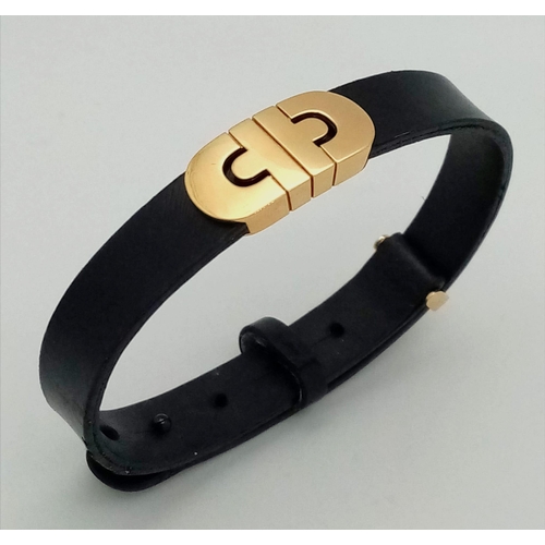 101 - A Bulgari Perentesi 18K Gold and Black Leather Bracelet. Comes in a Bulgari presentation case (worn ... 