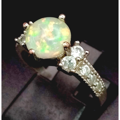 1058 - Silver Tone Metal and Fire Opal Ring with White Stone Shoulders. Total Weight 2.42grams. Size N.