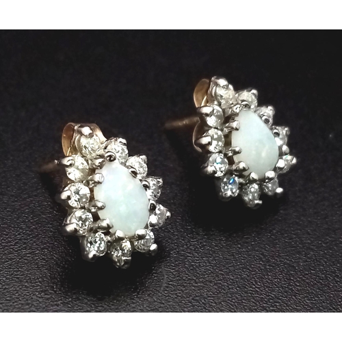 198 - A Vintage Fiery Opal and Diamond Pair of Pear Shaped Earrings set in 9k gold. 1.6g total weight