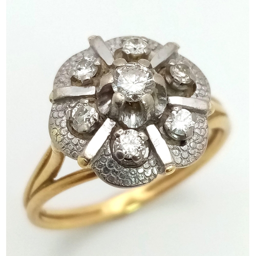 16 - A Vintage 18K Yellow Gold and Diamond Floral Ring. Central petal-cut diamond surrounded by a halo of... 