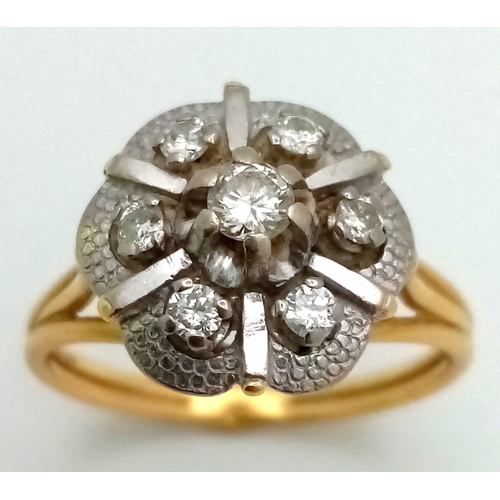 16 - A Vintage 18K Yellow Gold and Diamond Floral Ring. Central petal-cut diamond surrounded by a halo of... 