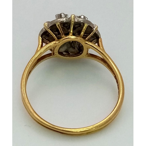 16 - A Vintage 18K Yellow Gold and Diamond Floral Ring. Central petal-cut diamond surrounded by a halo of... 