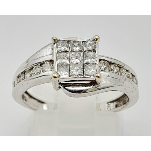 43 - An 18K White Gold and Princess Cut Diamond Ring. Nine small princess cut diamonds with seven graduat... 