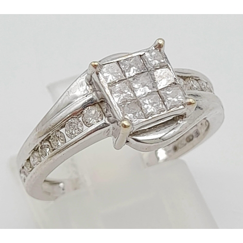 43 - An 18K White Gold and Princess Cut Diamond Ring. Nine small princess cut diamonds with seven graduat... 