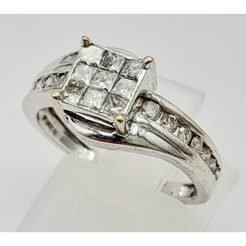 43 - An 18K White Gold and Princess Cut Diamond Ring. Nine small princess cut diamonds with seven graduat... 