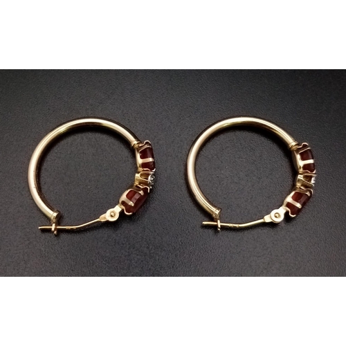 1625 - A Pair of 9K Yellow Gold Garnet Hoop Earrings. 1.25g total weight.