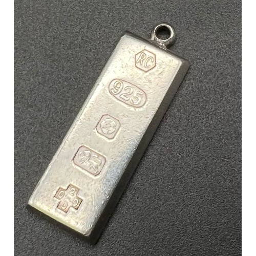 1617 - A sterling silver ingot pendant with Millenium hallmarks. Height: 35 mm, weight: 16.2 g.