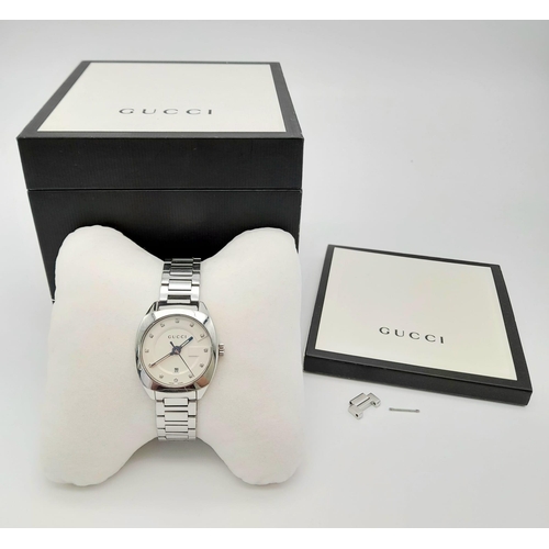 149 - A Gucci Quartz Ladies Watch. Stainless steel strap and case -29mm. Cream dial with date window and w... 