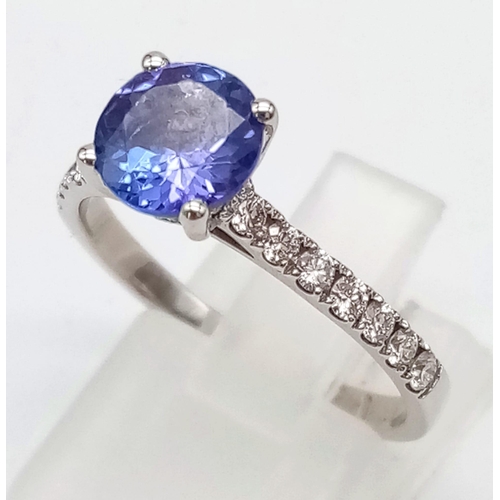 68 - PLATINUM DIAMOND & TANZANITE RING, WITH A 1.40CT ROUND TANZANITE CENTRE AND DIAMOND SET SHOULDERS. W... 