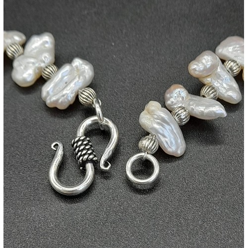 160 - A fantastic set of exotic elongated natural pearl necklace and earrings set, presented in a case. Ne... 