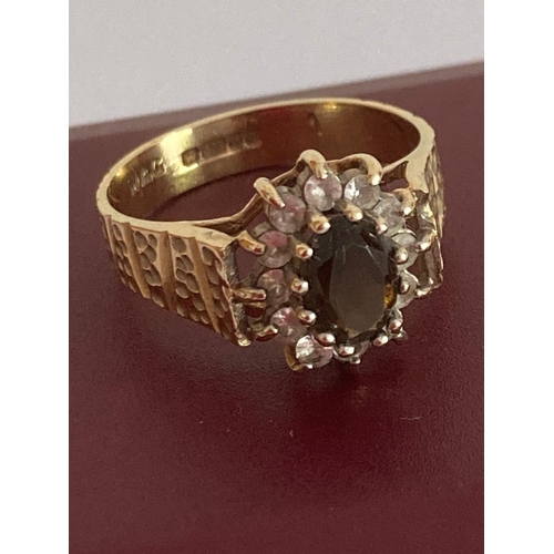 49 - Attractive 9 carat GOLD RING Having textured shoulders and set with Garnet and clear stones to top. ... 