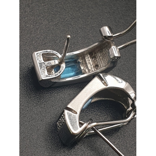 155 - A 14 K white gold pair of earrings with diamonds and either blue topaz or aquamarine.  Weight: 6.1 g... 