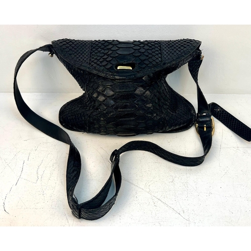 164 - A Gucci Black Python/Snakeskin Shoulder Bag. Gold-tone hardware. Adjustable shoulder strap. Spacious... 