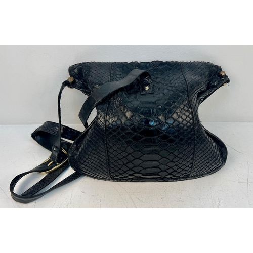 164 - A Gucci Black Python/Snakeskin Shoulder Bag. Gold-tone hardware. Adjustable shoulder strap. Spacious... 