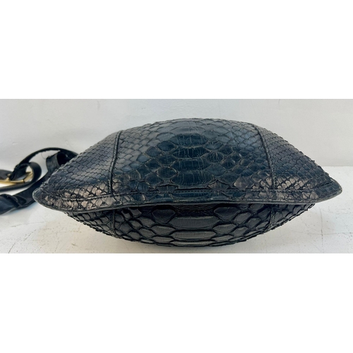 164 - A Gucci Black Python/Snakeskin Shoulder Bag. Gold-tone hardware. Adjustable shoulder strap. Spacious... 