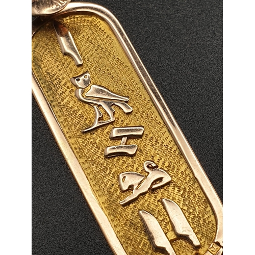 169 - A 14 K yellow gold pendant in the shape of ancient Egyptian cartouche with hieroglyphics. Length: 46... 