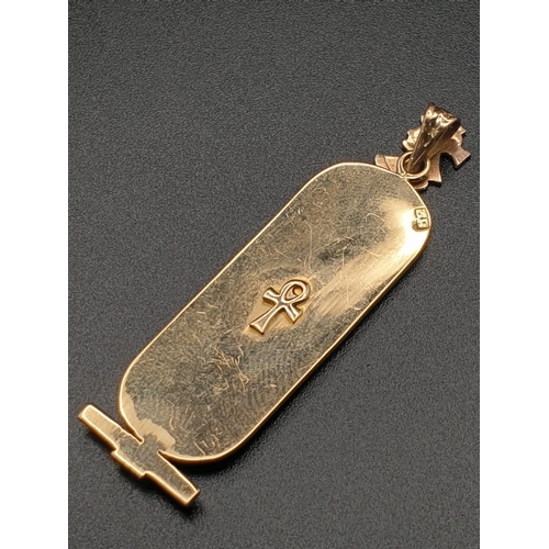 169 - A 14 K yellow gold pendant in the shape of ancient Egyptian cartouche with hieroglyphics. Length: 46... 