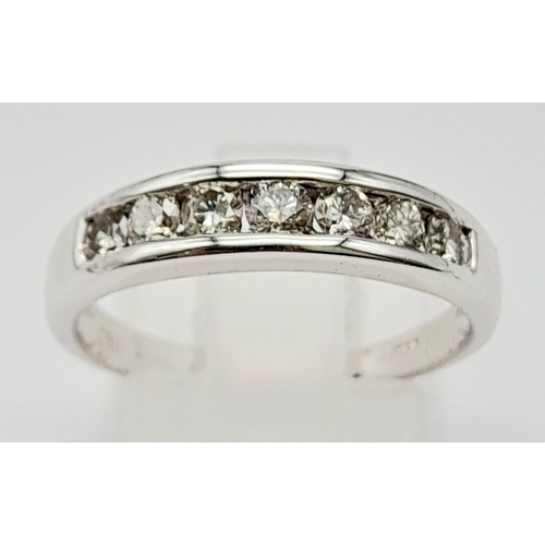 176 - An 18 K yellow gold ring with a channel set band of diamonds (0.25 carats). Ring size: N, weight: 3.... 