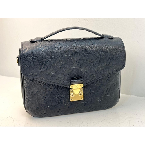 18 - A Louis Vuitton Pochette Metis Leather Bag. Black monogram empreinte leather. Zipped exterior compar... 