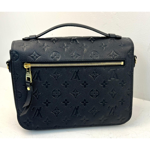 18 - A Louis Vuitton Pochette Metis Leather Bag. Black monogram empreinte leather. Zipped exterior compar... 