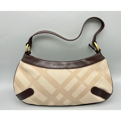 129 - A Burberry Baguette Pouch Bag. Exterior beige canvas with leather handle and trim. Textile interior ... 