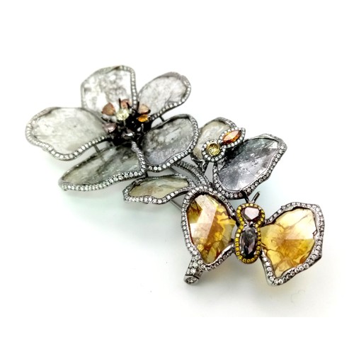 53 - A SHOW STOPPING DIAMOND BROOCH IN THE FORM OF FLOWERS AND A BUTTERFLY .   32.1gms   9cms in height.