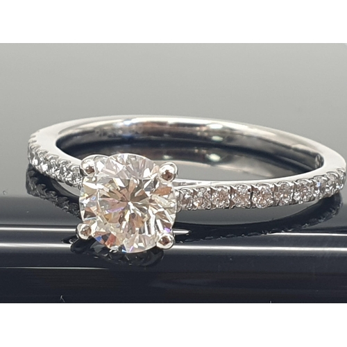 325 - A DELIGHTFULLY FEMININE .73ct DIAMOND RING SET IN PLATINUM WITH DIAMOND SHOULDERS AND GIA CERTIFICAT... 