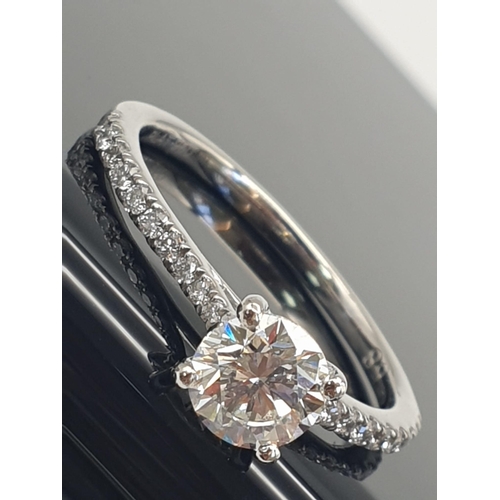 325 - A DELIGHTFULLY FEMININE .73ct DIAMOND RING SET IN PLATINUM WITH DIAMOND SHOULDERS AND GIA CERTIFICAT... 