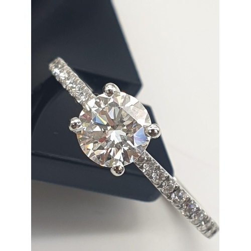 325 - A DELIGHTFULLY FEMININE .73ct DIAMOND RING SET IN PLATINUM WITH DIAMOND SHOULDERS AND GIA CERTIFICAT... 