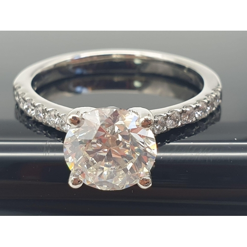 51 - A FABULOUS 2.01ct DIAMOND RING SET IN PLATINUM WITH DIAMOND SHOULDERS .   5.3gms   size N