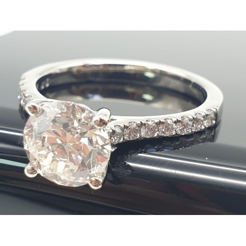 51 - A FABULOUS 2.01ct DIAMOND RING SET IN PLATINUM WITH DIAMOND SHOULDERS .   5.3gms   size N