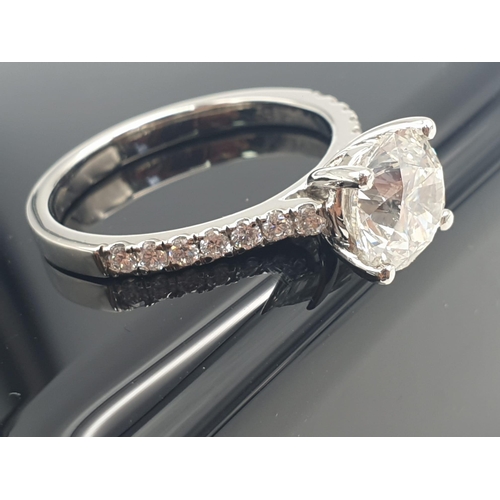 51 - A FABULOUS 2.01ct DIAMOND RING SET IN PLATINUM WITH DIAMOND SHOULDERS .   5.3gms   size N