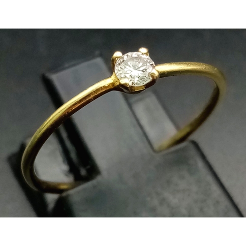 735 - An 18K Yellow Gold Diamond Solitaire Ring. 0.10ct. Size M.
0.85g total weight.