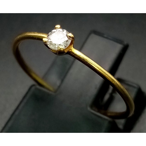 735 - An 18K Yellow Gold Diamond Solitaire Ring. 0.10ct. Size M.
0.85g total weight.