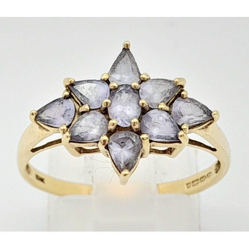 644 - A 9K Yellow Gold Amethyst Floral Decorative Ring. Size S. 2.4g total weight.