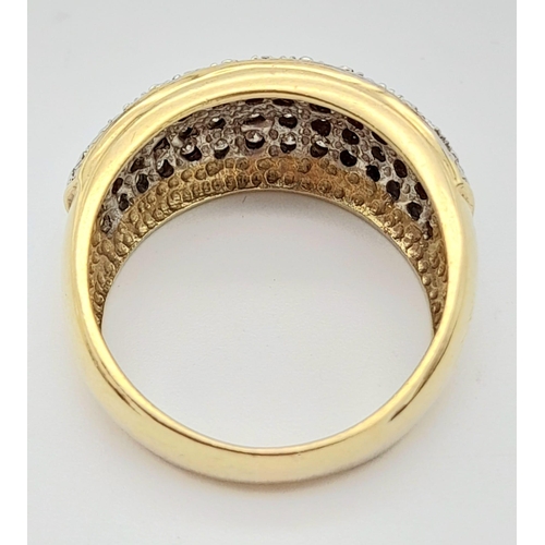 66 - A 9K Yellow Gold Diamond Encrusted Sloped Band Ring. Size P. Over 70 small diamonds. Size O 1/2. 6.3... 