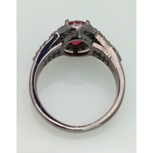 622 - A 2ct Ruby Ring with a Diamond Halo and Shoulders. Set in gunmetal 925 Silver. Size N. 3.94g total w... 