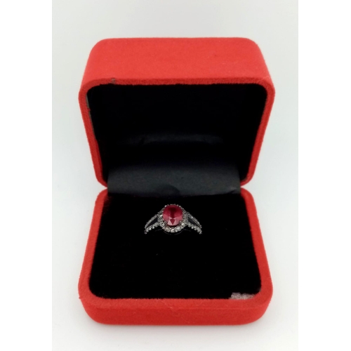 622 - A 2ct Ruby Ring with a Diamond Halo and Shoulders. Set in gunmetal 925 Silver. Size N. 3.94g total w... 