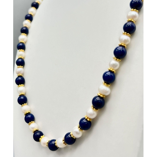 476 - A Cultured Pearl and Lapis Lazuli Matinee Length Necklace. 8mm lapis and pearls. Gilded spacers and ... 